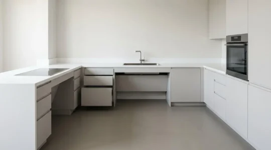 Modern wheelchair-accessible kitchen showcasing barrier-free design with lowered work surfaces and open knee clearance beneath countertops